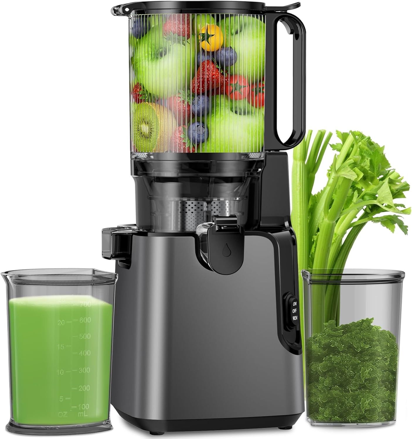Sleek dark gray slow juicer with wide chute filled with fresh fruits, alongside green juice and celery pulp.