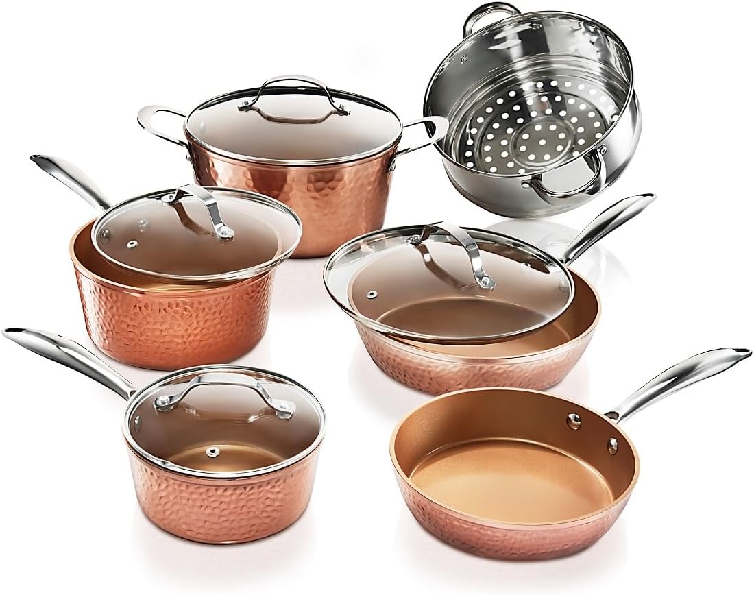 Luxurious 7-piece hammered copper cookware set with polished stainless steel handles on a gray background.