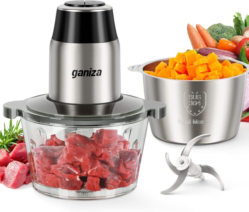 Powerful electric food chopper dicing raw meat, with chopped squash and various blades on a light blue backdrop.