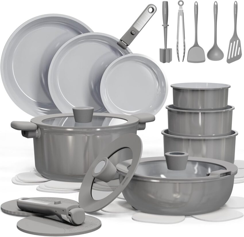 Modern grey non-stick cookware collection with pots, pans, lids, utensils, and storage containers arranged on a light background.