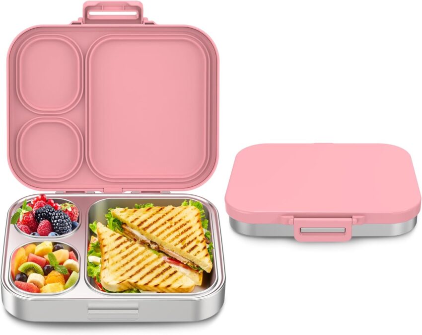 Sleek pink and silver bento box, one side open with fruit and sandwiches, beside a closed matching box.