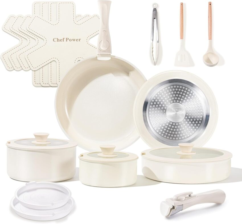 Pristine off-white ceramic nonstick cookware set with frying pan, stock pot, and glass lids on gray.