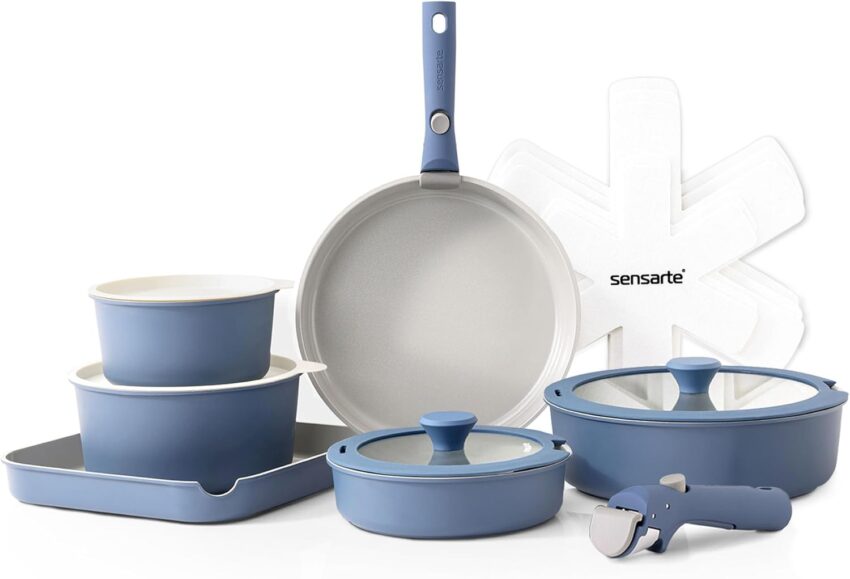 Full blue and light gray non-stick cookware set with pans, pots, and tools on a light gray backdrop.